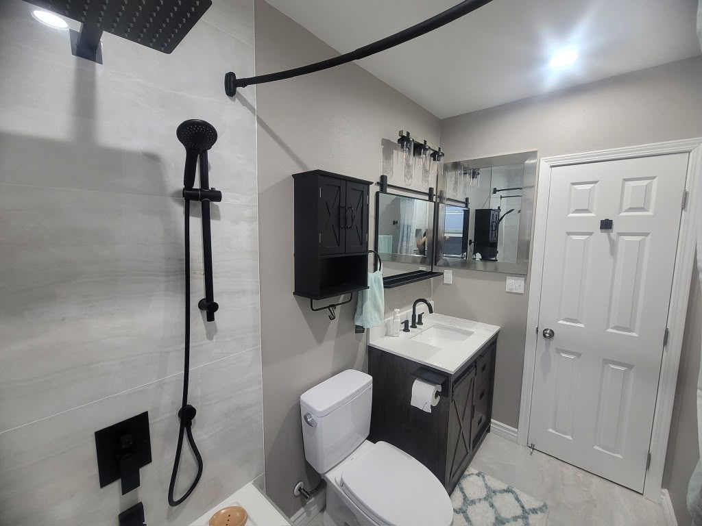 Finished Covina bathroom with large-format tile and black fixtures